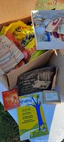 Box containing unopened packages, sewing tools, buttons, and notions showing variety of vintage sewing room items