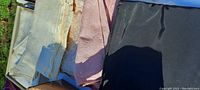 Close-up photo of assorted vintage fabrics in cream, pink, and black with varied textures and weights