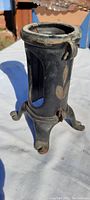 Front angle view showing hand painted floral design and legged base of tree stand