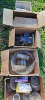 Boxes containing various antique pressed and cut glassware including pitchers, bowls, plates, and glasses