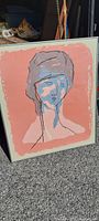 Full view of the framed 1960s abstract portrait painting depicting a stylized female figure with a large headpiece in muted colors on peach background.