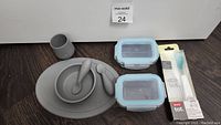 Complete lot contents showing EZPZ feeding set, glass containers, and Oxo Tot spoon in packaging.