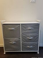 Front view of fabric storage organizer with two columns of fabric drawers, left column has two large drawers, right column has three smaller drawers.