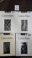 Four packages of Calvin Klein nylons including criss-cross lines, bold stripe, matte opaque heather, and double line fishnet styles.