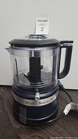 Front view of KitchenAid 3.5 cup food chopper showing base, work bowl, and lid with handle and spout