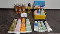 Full view of all included hand creams and shower oils, including travel-sized bottles and tubes in various scents and packaging.