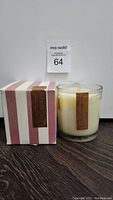 Photo of scented candle in glass with striped box and Pottery Barn label