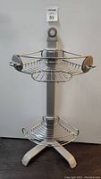 Front view of Simplehuman corner shower caddy showing two wire shelves and stability base.