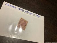 Close-up of the hinged back of the 1898 Canada two-cent Queen Victoria stamp, showing mounting marks.