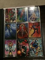 Front view of nine Boris Vallejo collector cards in binder sleeve featuring fantasy and superhero characters in colorful artwork.