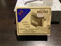 Front side of original box for Uvitec Micro ultraviolet lamp showing product image and usage info.