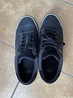 Top-down view of men's UGG black nubuck leather lace-up shoes size 8.5 showing UGG branding inside the shoe and condition of uppers and laces.