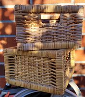Photo of two rectangular wicker storage boxes stacked showing design and weave pattern.