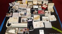 Overview of tray containing assorted costume jewelry items in multiple boxes