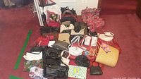 Full view of assorted purses and handbags, showcasing various styles and colors including red, black, beige, white, and woven materials.