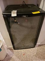 Frontal view showing the entire Danby wine refrigerator with glass door and visible internal shelf.