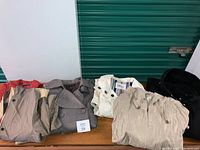 Lot photo showing five long jackets and raincoats in various colors including beige and black