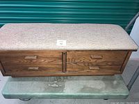 Front view of Lane cedar chest showing padded top and decorative drawers with wood handles.