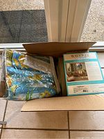 Boxed Waverly SunNshade curtains next to the Beaches drape in package
