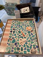 Fuji FinePix camera in box and Hallmark scrapbook album with sea glass and seashell design on cover