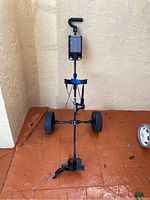 Front view of the Intech lightweight steel frame golf cart showing the handle, cup holder, and wheels.