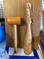 Photo showing both wood mallet with ribbed head and fish bonker with engraved text and strap