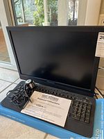 Photo of Sylvania monitor, Azio EZ Eyes keyboard, Phillips Pixel Plus camera, and keyboard instructions
