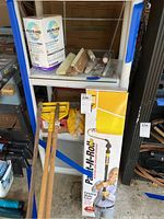 Shelf view showing Paint-N-Roll box, brushes, gloves, grout box, and handles