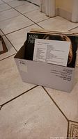 Photo of box with visible LP albums inside, one album titled Daddy Man visible.