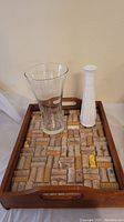 Full view of the wood serving tray showing cork inset and two vases placed inside