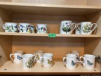 Top shelf and middle shelf showing multiple tea cups with floral and butterfly designs.