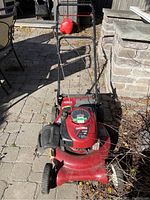 Front view of the red Craftsman 675 lawnmower showing the engine and handlebar.