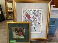 Two framed artworks featuring cardinals, one larger signed painting by Don Li-Leger, one smaller print by Robert Bateman.