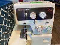 Close-up of the Kenmore serger machine showing tension dials and differential feed label.
