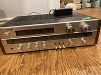 Front angle view of the Sony STR-V3 receiver showing control knobs and overall condition.