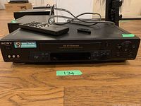 Front view of Sony SLV-N71 Hi-Fi Stereo Video Cassette Recorder showing controls, display, RCA input jacks, and included remote on top.