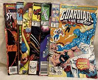 Stack of 7 Marvel comic books including Spider-Man and Guardians of the Galaxy with visible wear.