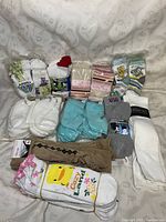 Photo shows multiple packages of assorted socks in various colors and patterns including white, pastel blue, cartoon prints, stripes and beige argyle.