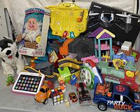 Overview of assorted toy box contents including plush toys, interactive toys, vehicles, and playsets.