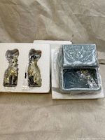 Si and Am Siamese cat ceramic salt and pepper shakers in original styrofoam packaging with blue ceramic basket in original box, wrapped in plastic.