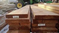 Stack of eight wood boards, end view showing thickness and label