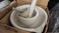 Lot shows 3 ceramic medicine bowls with stirring sticks/pestles of varying sizes, nested in a box.