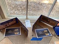 Two commemorative bank notes in protective holders with labels showing 2020 Proof Jefferson Nickels