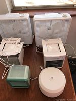 Lot shows six fans and humidifiers, including two large box fans, two evaporative coolers, one small humidifier, and one small USB fan.