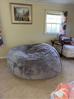 Full view of round grey bean bag chair in room