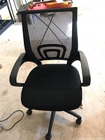 Front view showing the seat, mesh back with geometric lumbar support pattern, and armrests
