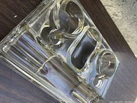 Top angled view of the glass inkstand showing the two round inkwells and double pen rest with 'Made in England' stamp on base.