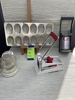 Overall grouping of the four kitchen items: madeleine tin, mini chopper, fry maker, and can crusher displayed on a surface.