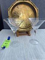 Photo of the octagonal brass tray with inset decoration and two clear etched martini glasses in front, showing tarnishing on the tray and good condition glasses