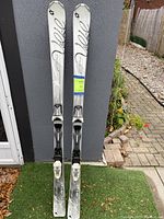 Front view of the Völkl skis standing upright against a wall, showing full length and bindings.